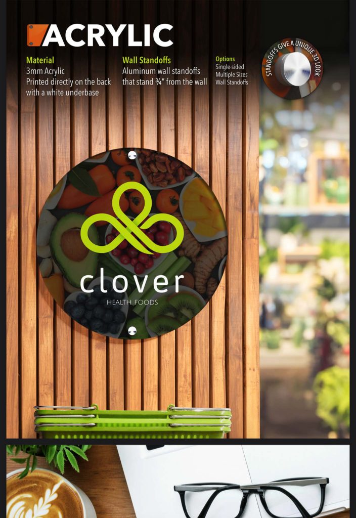 Colorful clover logo sign with greenery backdrop
