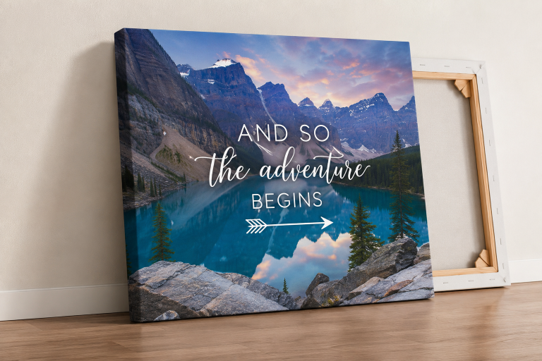 Canvas print of a mountain lake photo with adventure quote leaning against a wall