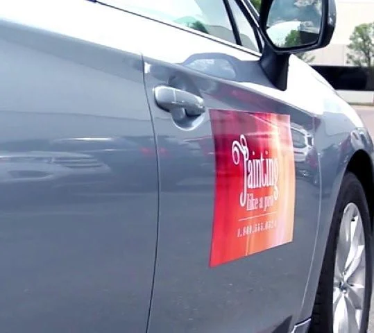 Sample printed magnet displayed on the door of a silver vehicle