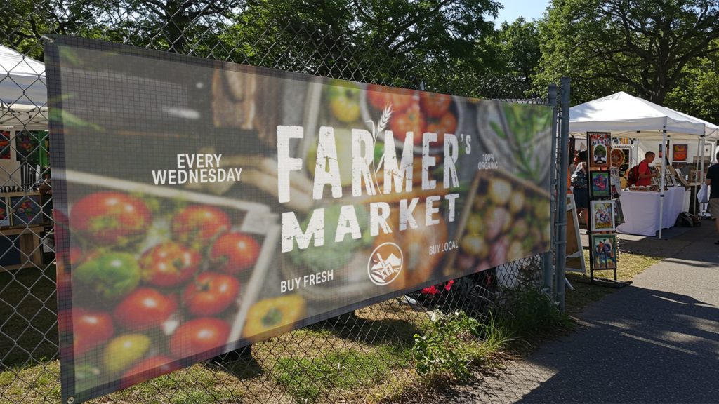 Custom mesh banner displayed at a farmers market