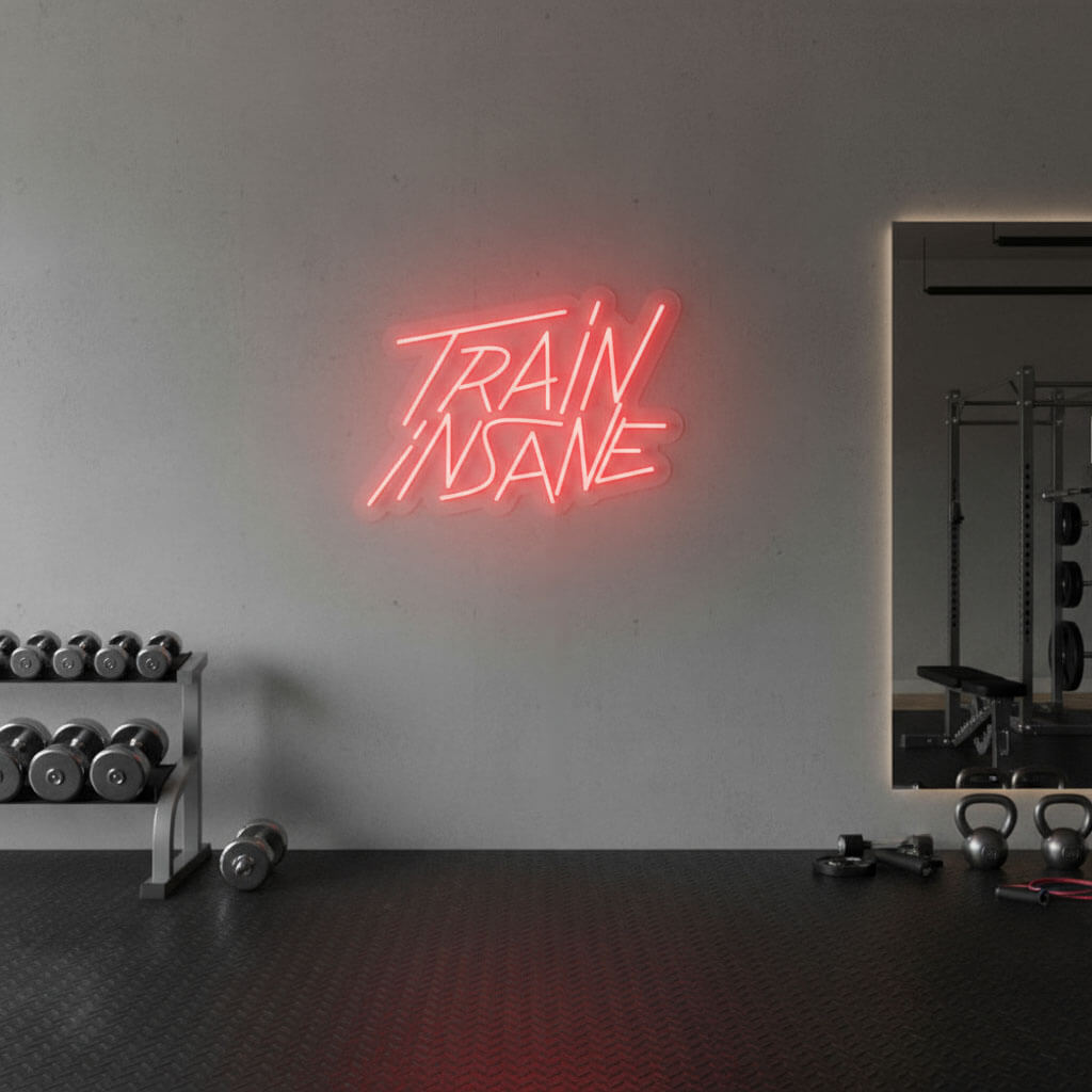 Train Insane – Gym LED Neon Sign shown in a room setting